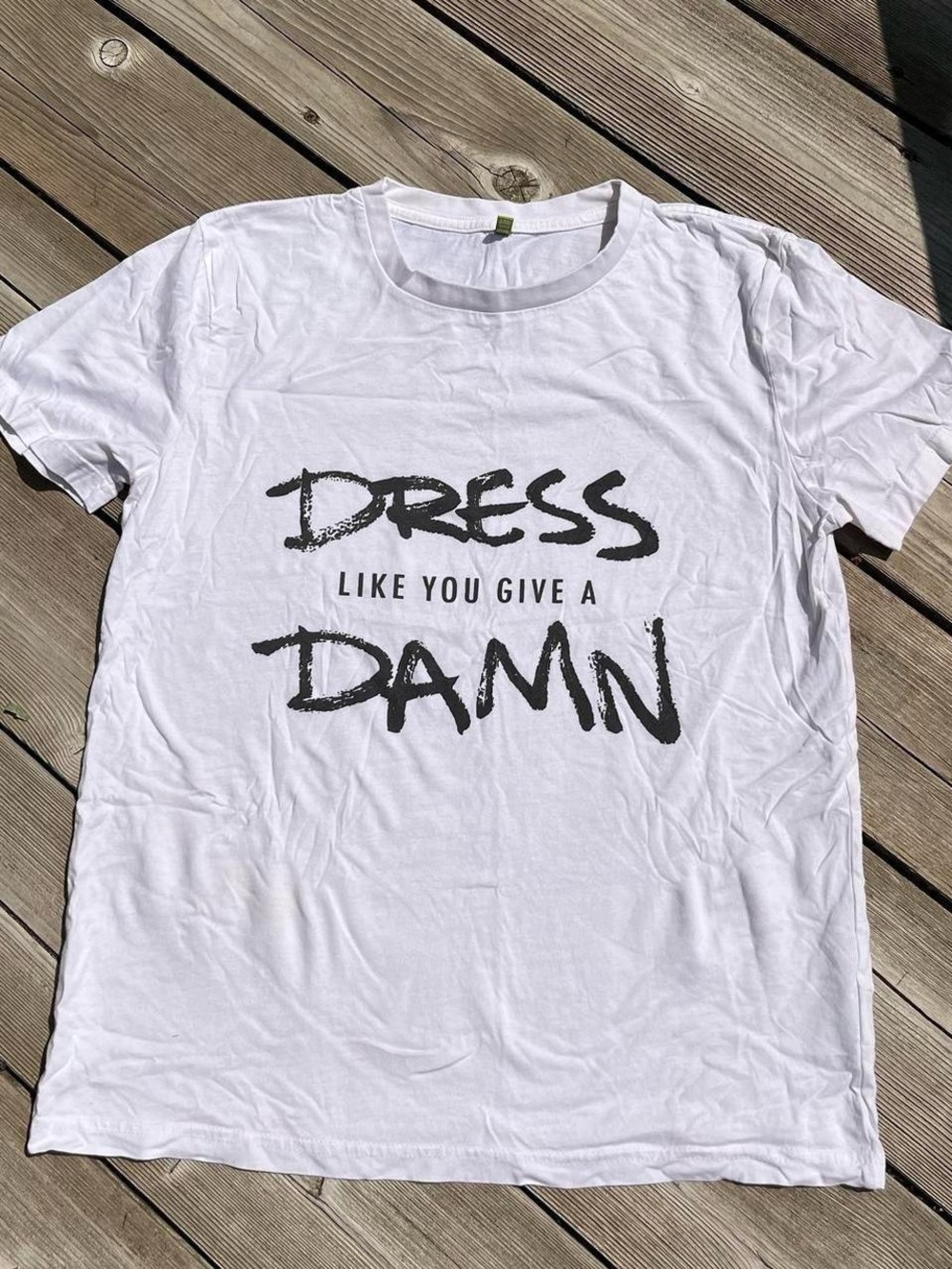 Rapanui White Graphic Tee with Bold Black 'DRESS LIKE YOU GIVE A DAMN' Print